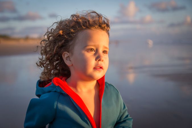 Little girl walking on seashore
