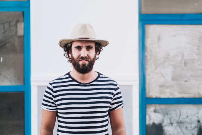 Young male in hat and striped t-shirt