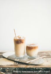 Two cups of iced coffee in clear classes with eco friendly straight on light background 5akzdb