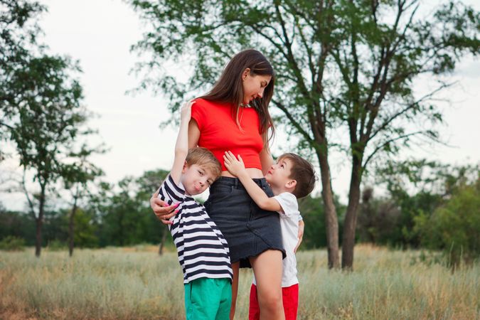 Loving mom with two sons outdoors