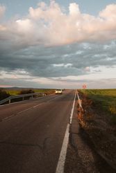 car on road along rural landscape