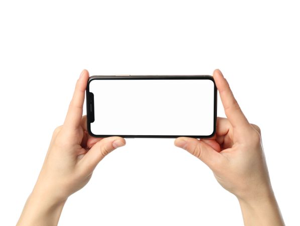 Female hands holding phone with empty screen, isolated on blank background