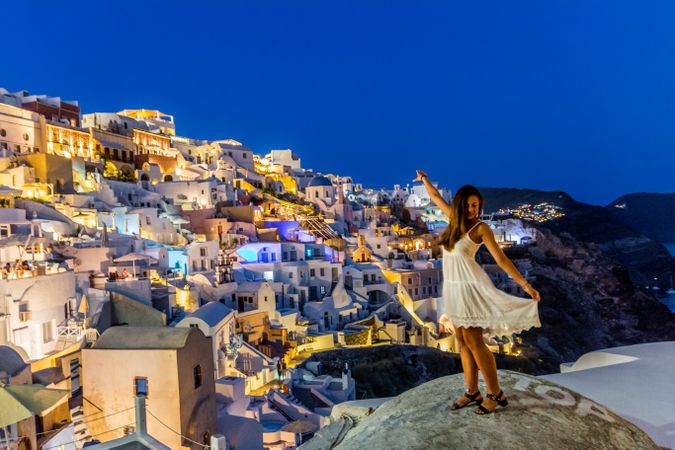 Woman standing near Santorini Greece during nighttime