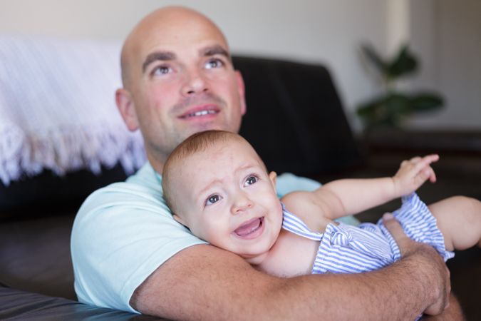 Father with baby sitting al floor