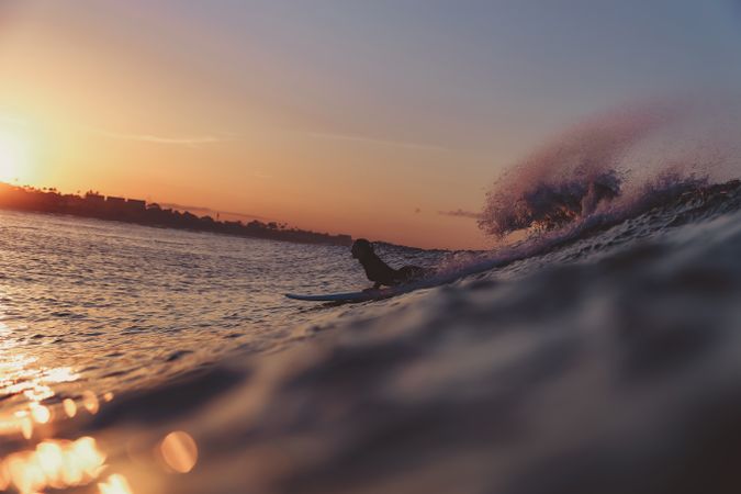 Woman on surf board on waving water