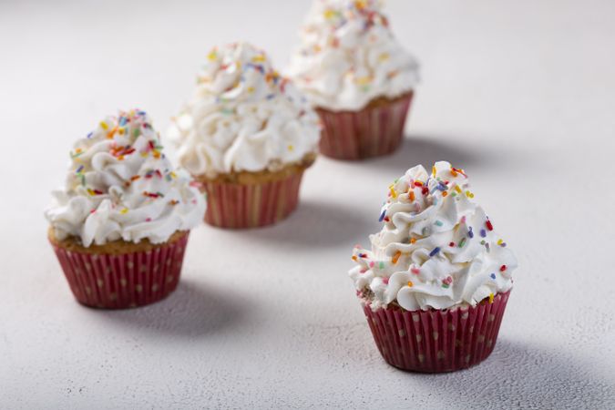 Tasty party cupcakes on the table. Cupcakes with whipped cream.