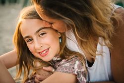 Woman with daughter on sunny beach