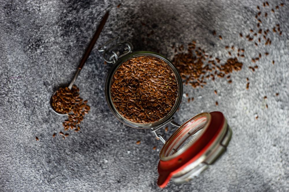 Top view of pot and spoon of flax seeds