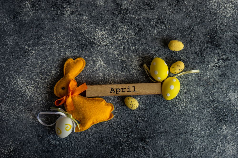 Easter card concept of grey counter with decorative small yellow eggs and rabbit ornament