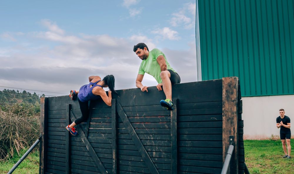 Participants in obstacle course climbing wall