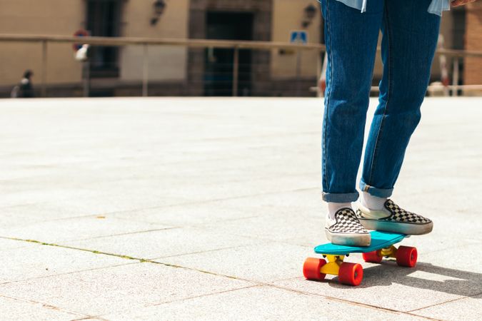 Legs of women skating in a urban square, close-up