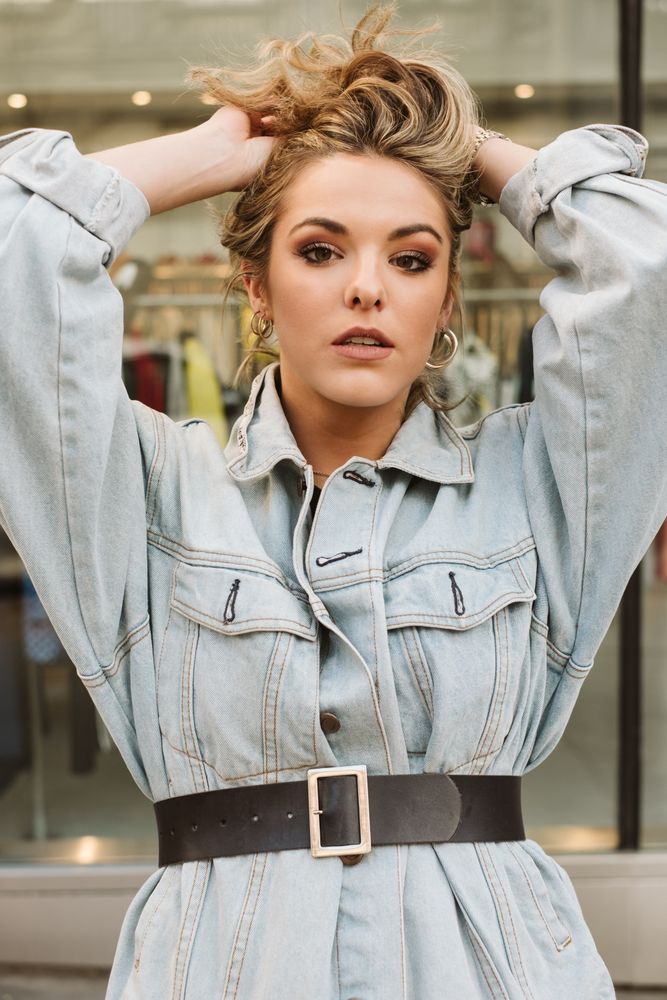Trendy woman looking at shop window