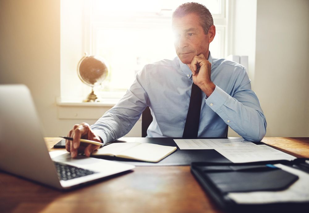 Man in business attire working at his laptop
