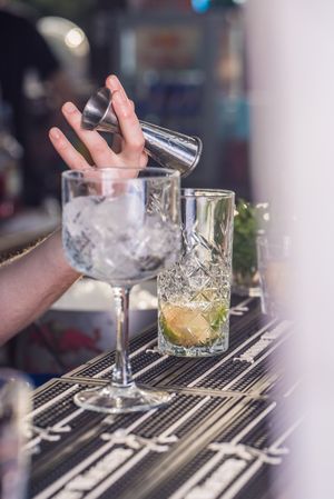 Bartender pouring an alcoholic beverage using jigger