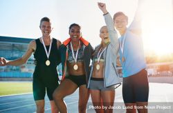Portrait of ecstatic young athletes together with medals 5a3DGb