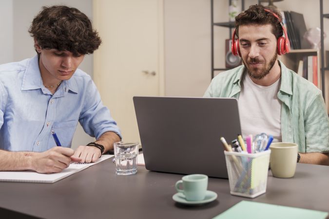 Men working at laptops
