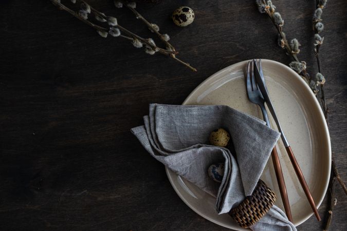 Top view of Easter table setting with quail eggs and pussy willow