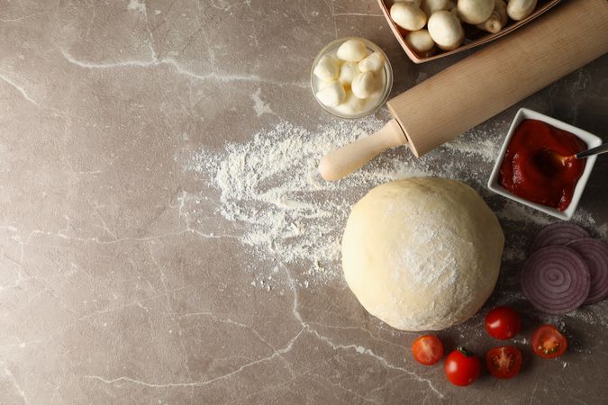 Ingredients for cooking pizza on gray background