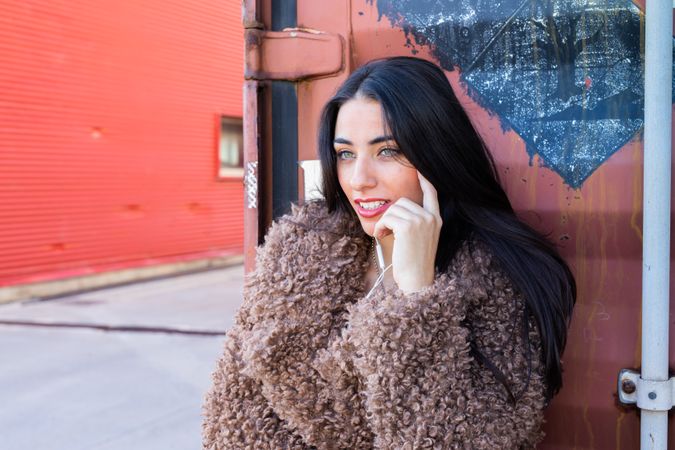 Stylish female near red wall