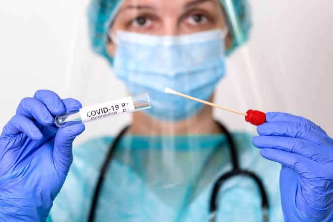 Healthcare worker holding Covid-19 testing kit