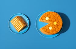 Medovik, russian honey cake, in bright light minimalist on a blue table