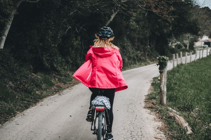 Female riding bicycle in countryside road