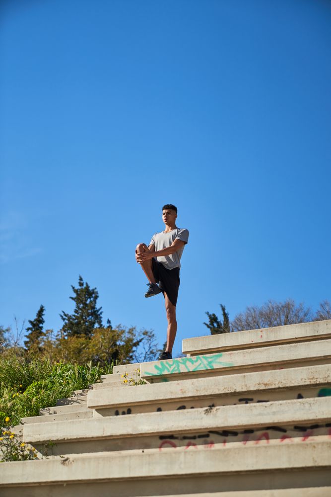 Man stretching legs on steps