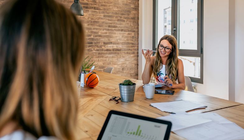 Office worker talking mobile phone with speaker