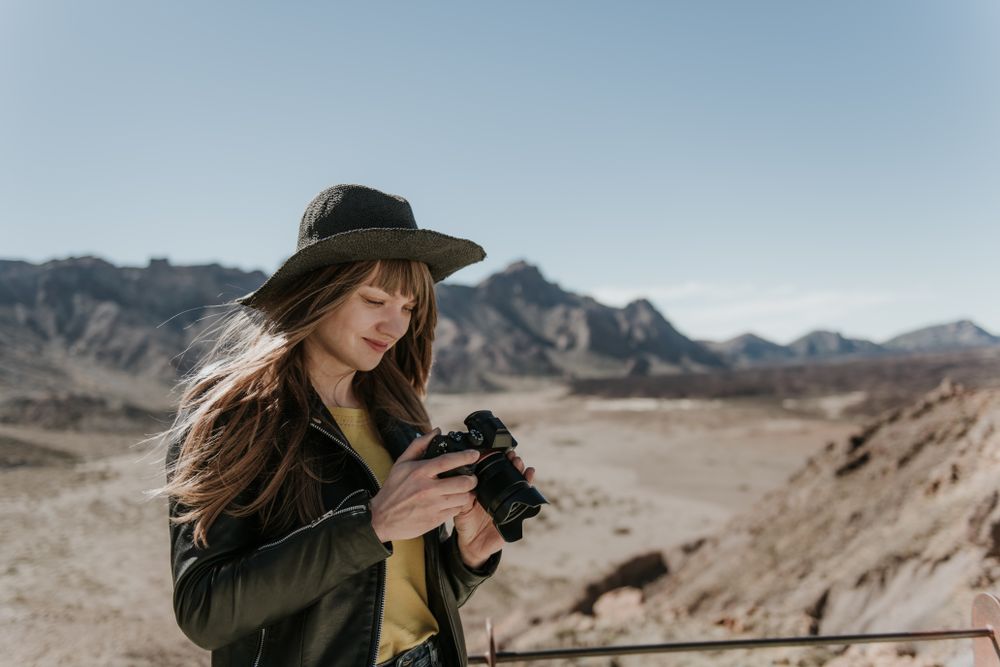 Woman with camera in desert