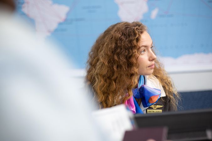 Woman working with guest at airport check in