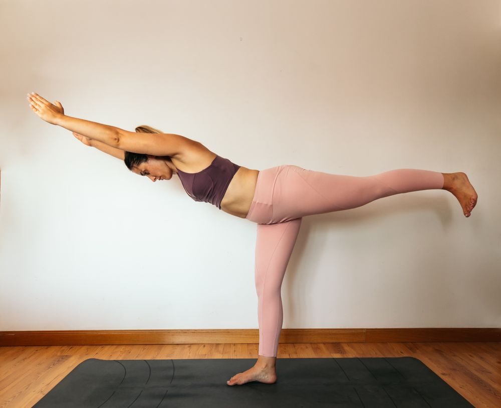Woman in sportswear doing yoga at home