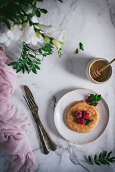 Pancake with fresh raspberry on plate