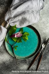 Floral scene with magnolia blooming on teal plate with napkin bYqGqD