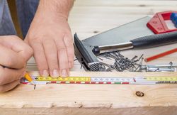 Woodworker hands and carpentry tools