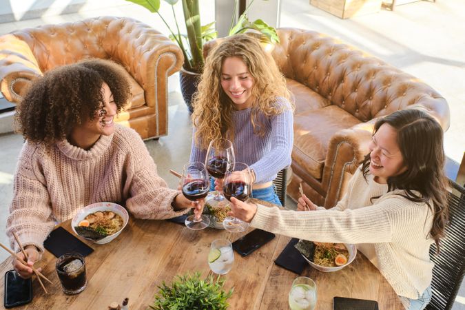 Cheerful diverse women having dinner