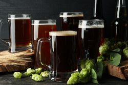 Beer, hop and wheat on wooden table