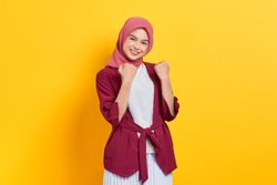 Woman in red headscarf playfully making two fists