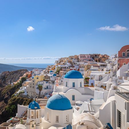 Square crop of Greek buildings overlooking the Aegean Sea