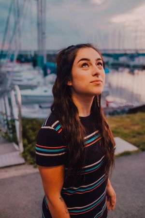 Smiling female walking along busy urban pier