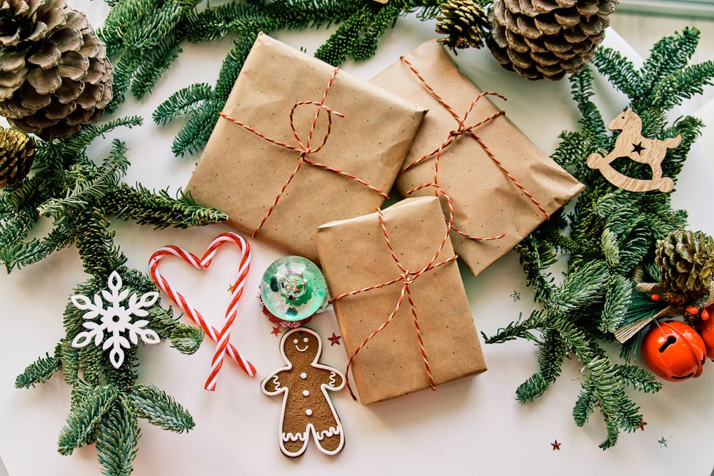 Christmas gifts and decorations arranged with coniferous twigs and cones