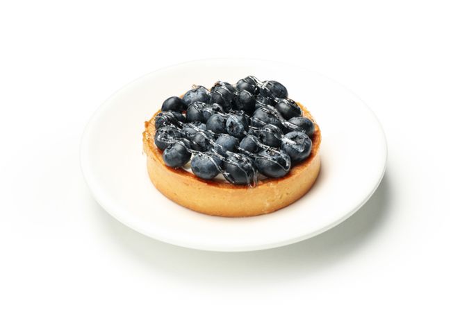 Plate with blueberry pie isolated on light background