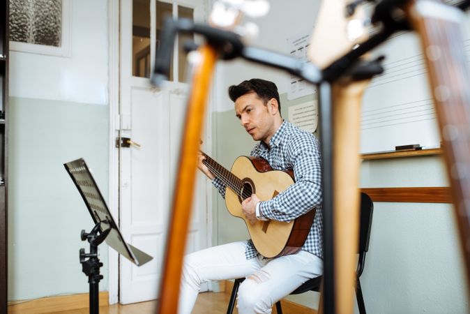 Man playing guitar in studio