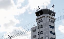 Air Traffic Control Tower Behind Barbed Wire Fence.