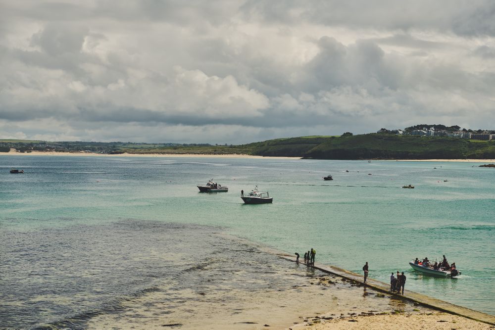 People and boats on a Cornish beach