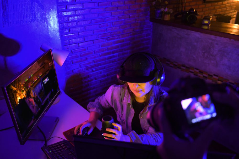 Woman with microphone and headphone working on a computer