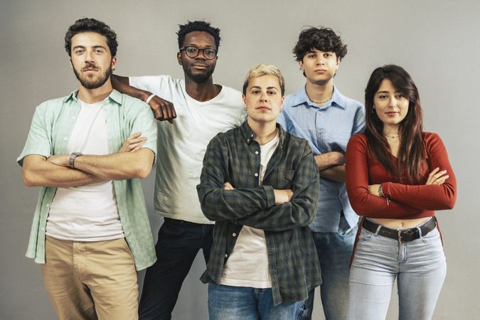 Group of diverse young people looking at camera with serious expression