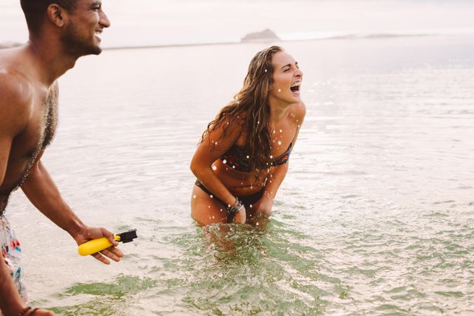 Close up of a couple having fun standing in sea water