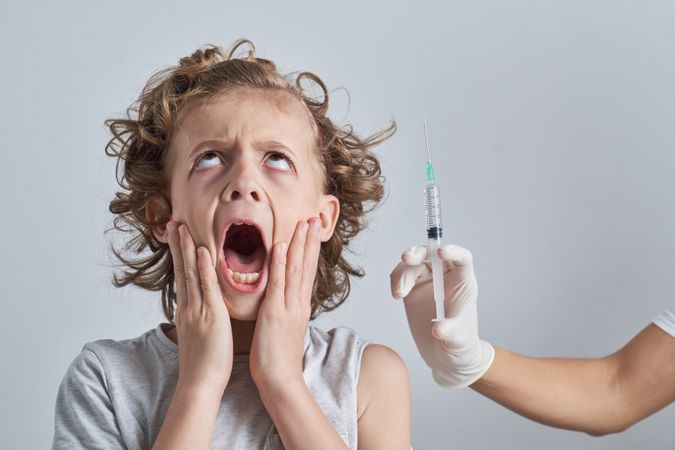 Boy scared because of syringe