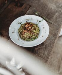 beans hummus in plate close to vegetables plateplate of delicious Mujaddara