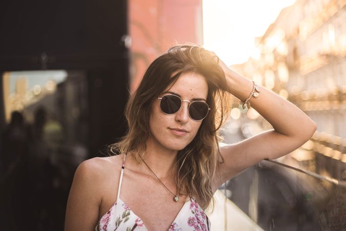 Dreamy woman against sunny blurred background